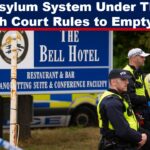 Police officers in high-visibility jackets stand outside The Bell Hotel in Essex, the site of protests and a court ruling on housing asylum seekers.