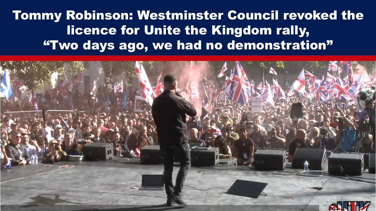 Expose News: Man on stage addressing lively crowd with flags at Unite the Kingdom rally; licence revoked by Westminster Council just two days prior.