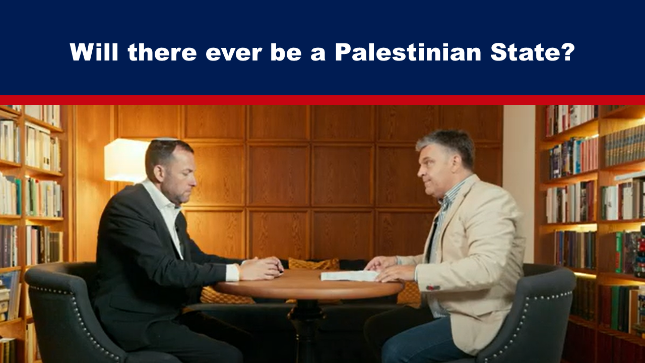 Expose News: Two men engaged in a lively discussion about the future of a Palestinian State, surrounded by bookshelves.