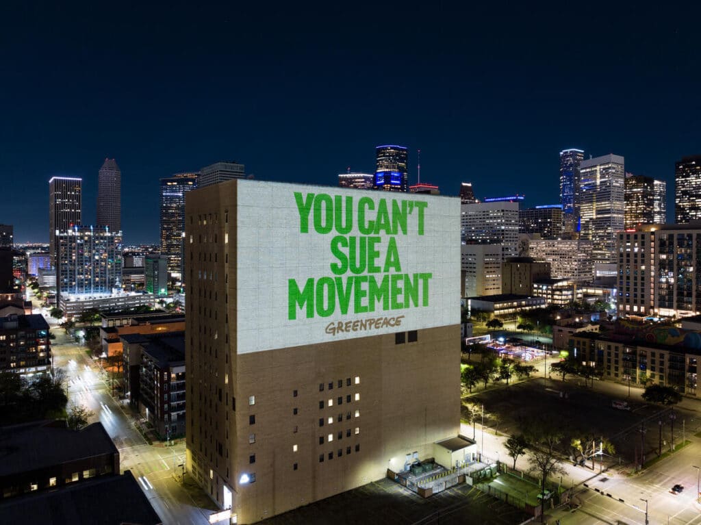 Expose News: Greenpeace projects defiant message on a building amid 5 million fine. Is this the end for the climate activists?