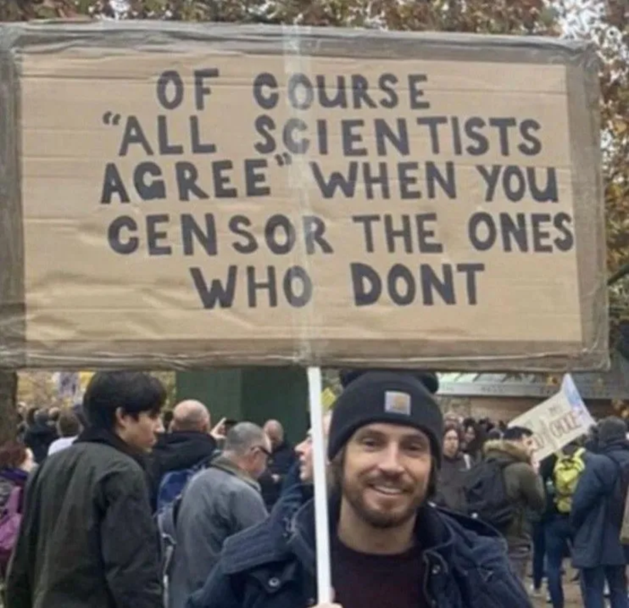 Expose News: Protestor holds a sign questioning scientific consensus, echoing themes from 'Canary in a Climate World': Losing My “Progressive” Religion.