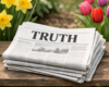 A newspaper with a title saying: True. Sat on a bench surrounded by Tulips and Dafodil