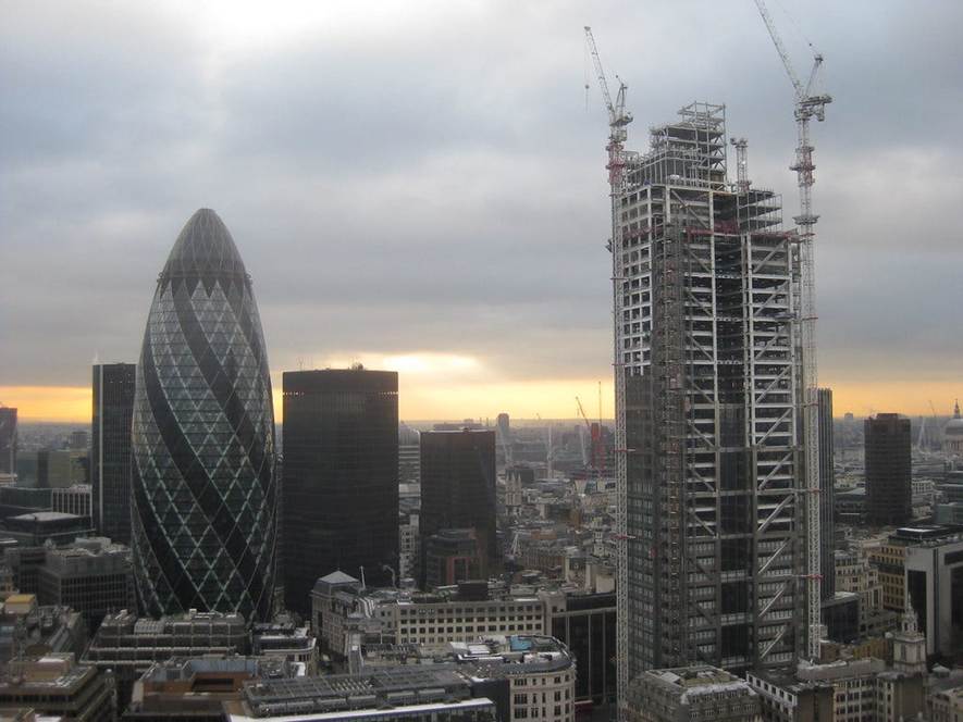 Expose News: Discover how the monetary system is designed to enslave you and your government, as seen in this bustling city skyline!