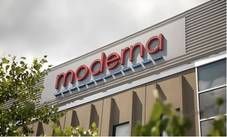 Moderna sign on the side of a modern office building with trees in the foreground.