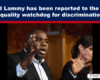 News banner: 'David Lammy has been reported to the UK's equality watchdog for discrimination' with a blue header and red underline; man in a suit speaking with expressive hands.