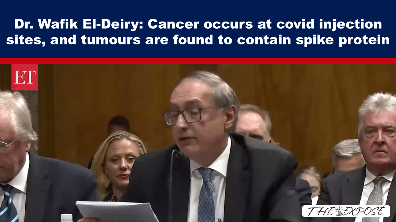 Television news screenshot of a man in a suit speaking at a hearing; headline reports cancer at covid injection sites and spike protein in tumors.