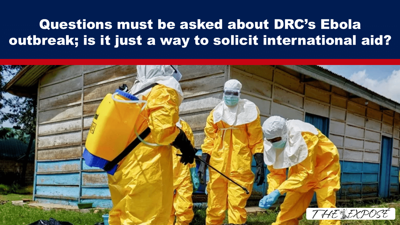 Medical workers in yellow hazmat suits disinfect an outdoor area beside a wooden building during an Ebola outbreak cleanup.
