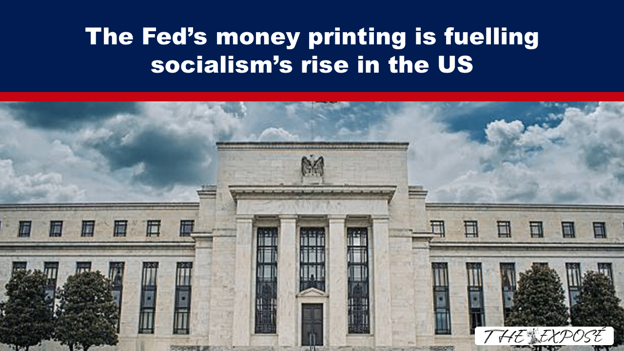 Blue banner with bold white text accusing the Fed of fueling socialism in the US above a neoclassical government building; watermark The Exposé.