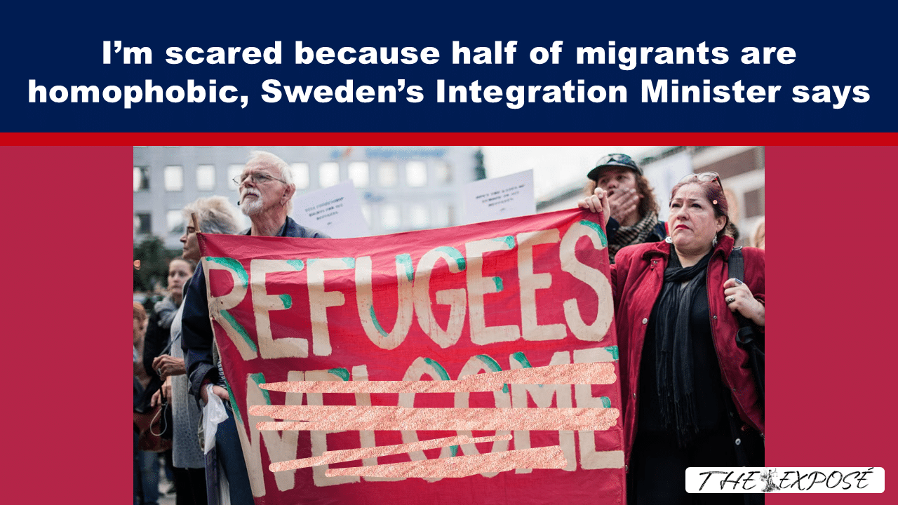 Protesters on a city street hold a large red banner reading 'REFUGEES' as others surround them.