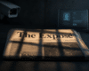 A folded newspaper titled “The Exposé” lies under warm light on a dark desk, crossed by prison-bar shadows, while blurred CCTV and digital-verification devices loom in the cold, shadowy background.